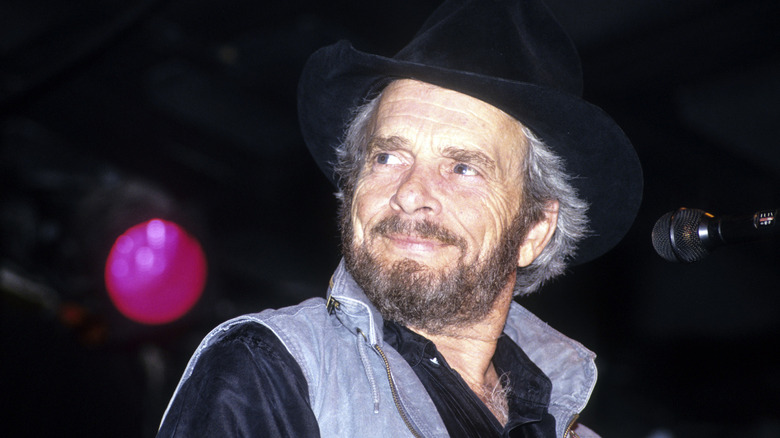 Merle Haggard smiling in a cowboy hat