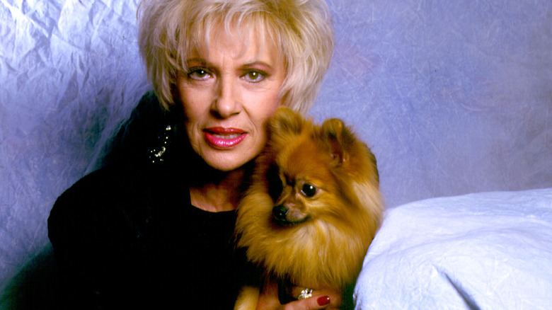 Tammy Wynette sitting for a posed photo with her dog