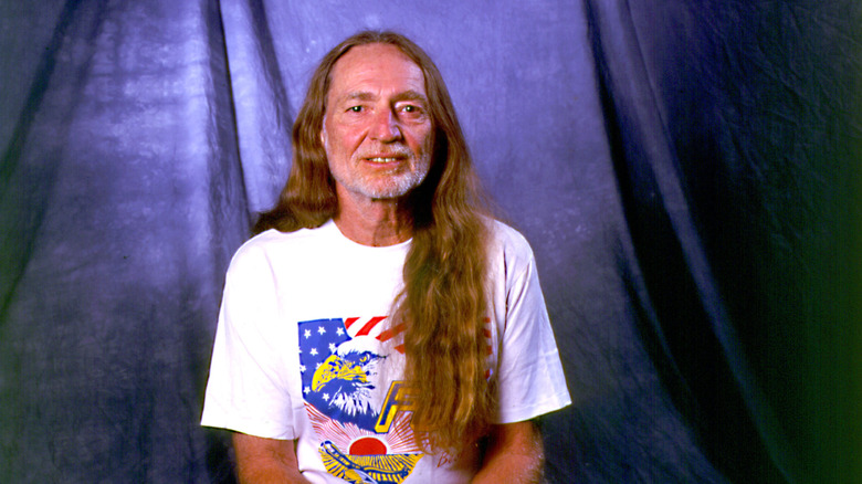 Willie Nelson posing in a patriotic t-shirt