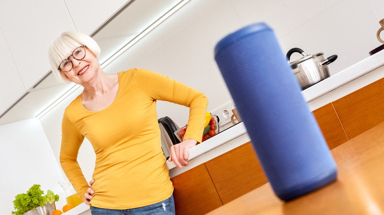 An elderly woman and a smart speaker