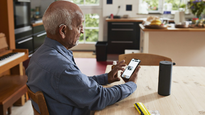 Elderly man using his smartphone