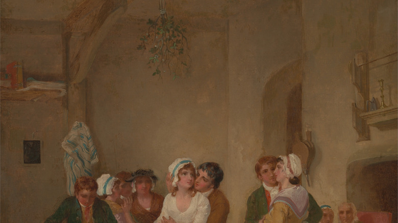 Couples kissing under mistletoe