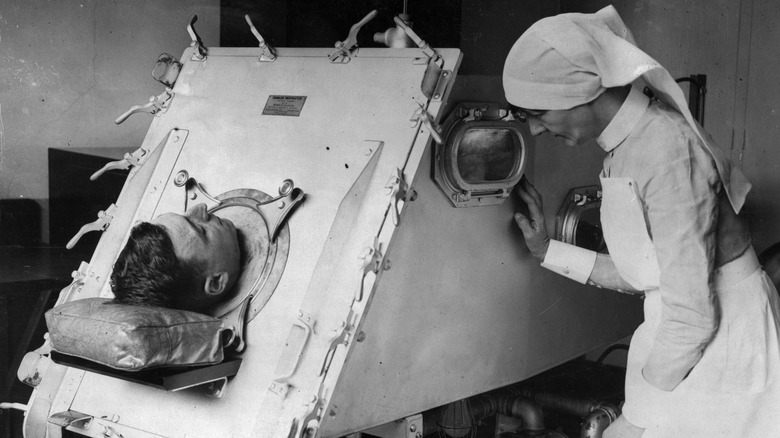 patient in iron lung with nurse