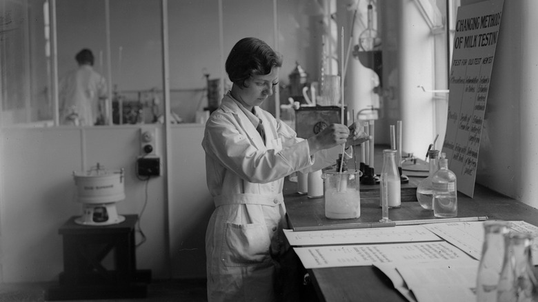 lab worker testing milk in 1930