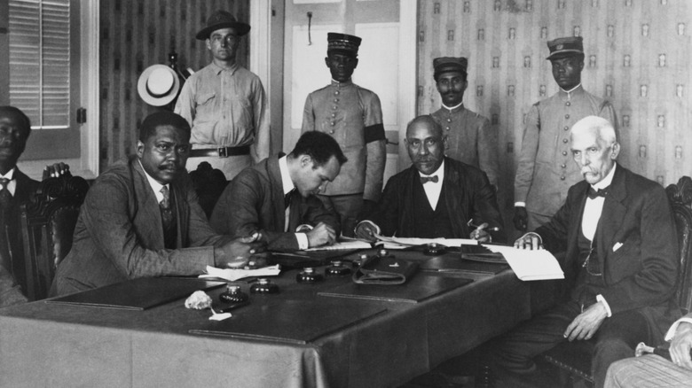 president of haiti and american bodyguard in meeting with other haitian politicians