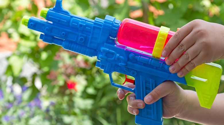 kid hands on high powered water gun