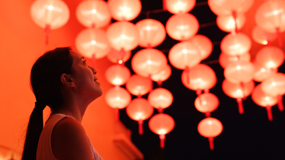 woman looking at red lanterns