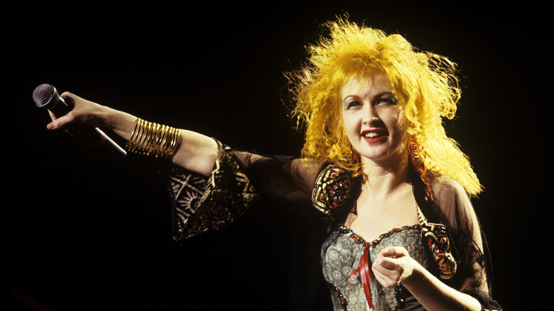 Cyndi Lauper holding out microphone