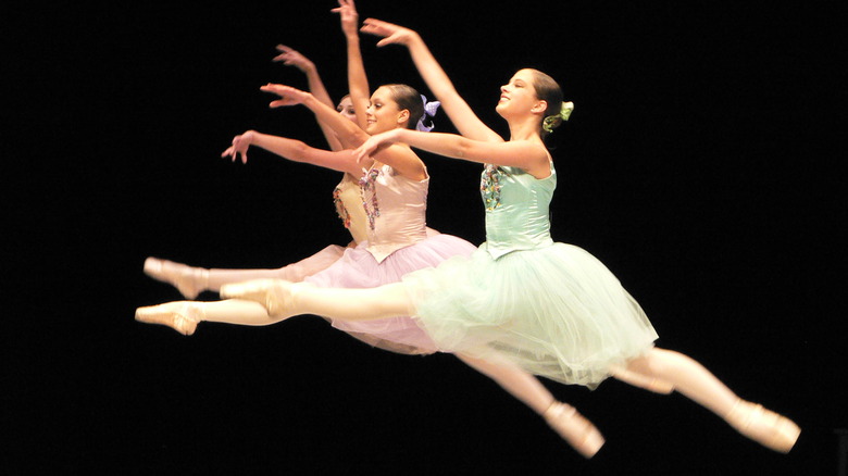 dancers performing a grandjete