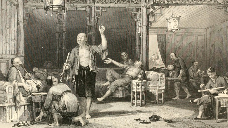 Chinese men lounging in opium den