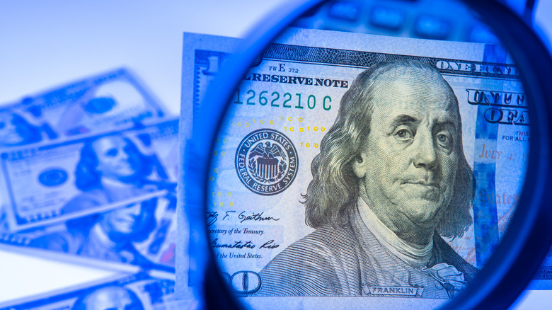 money magnified by magnifying glass