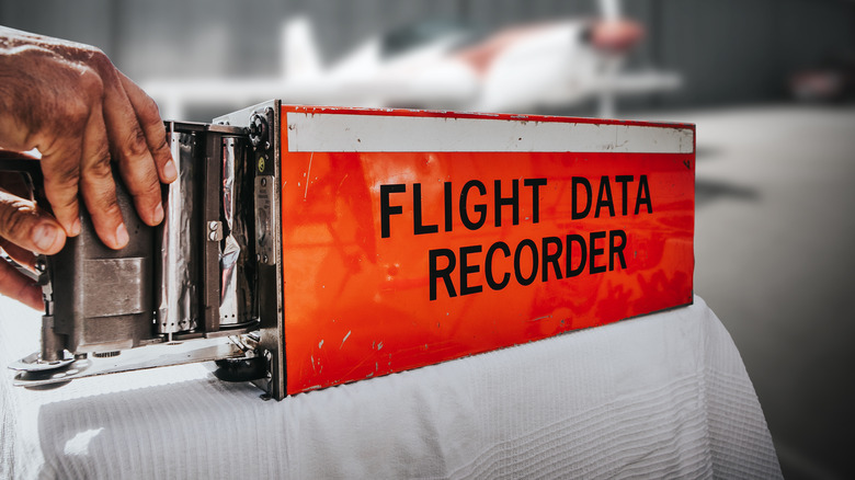Hand holding flight data recorder