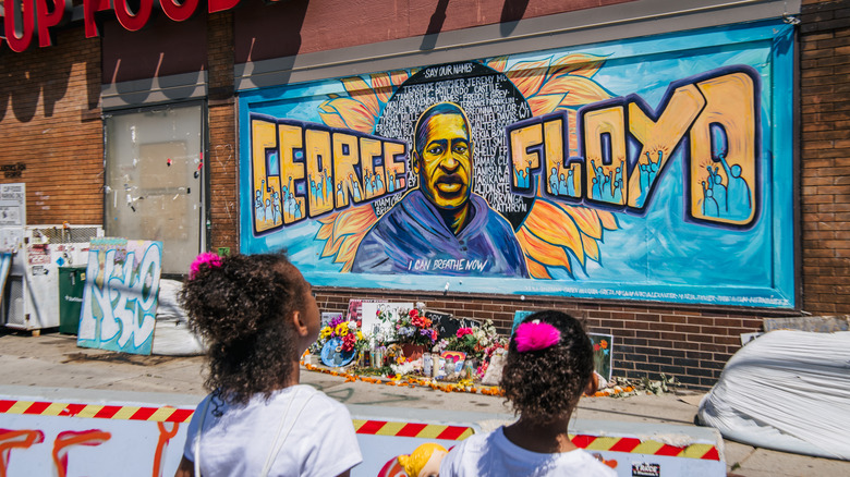 Children view George Floyd mural