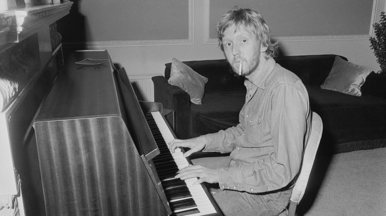 Harry Nilsson playing piano smoking cigarette