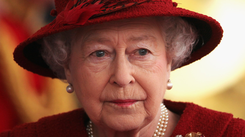 Queen Elizabeth II in red hat