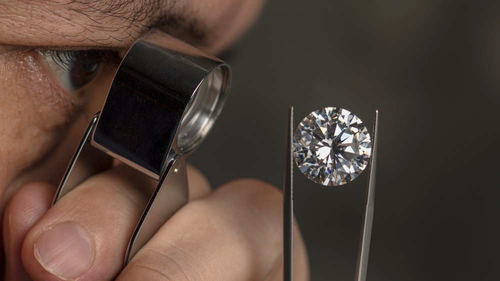 A jeweler takes an up-close look at a diamond