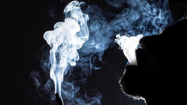 Person blowing pot smoke