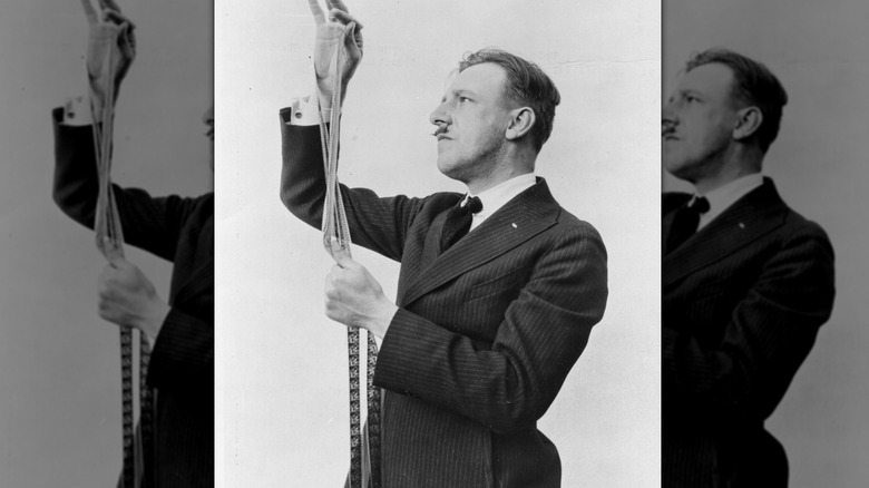 Tod Browning inspects a strip of film