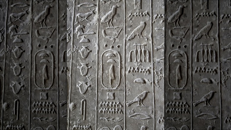 Vertical hieroglyphics on grey stone