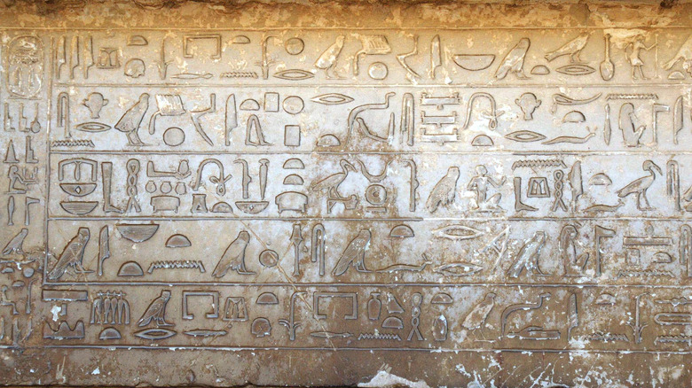 Hieroglyphic inscriptions on worn tan stone
