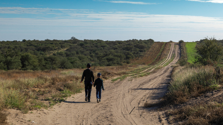 mennonite children walking down dirt road