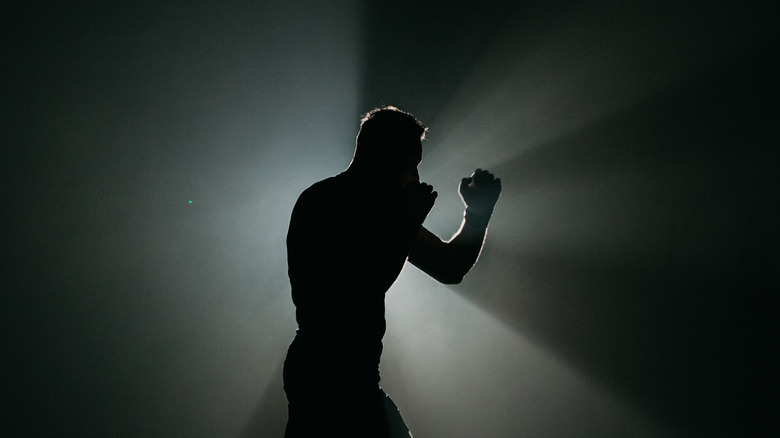 person boxing in darkness