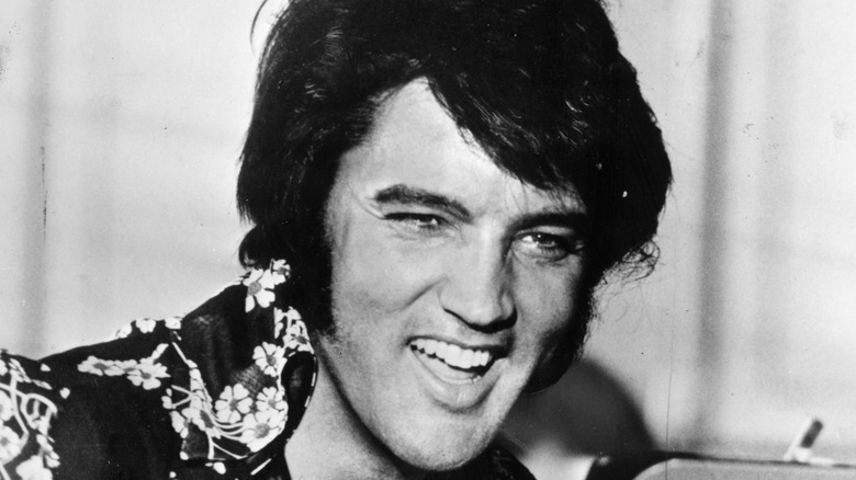 Elvis Presley smiling in Hawaiian shirt