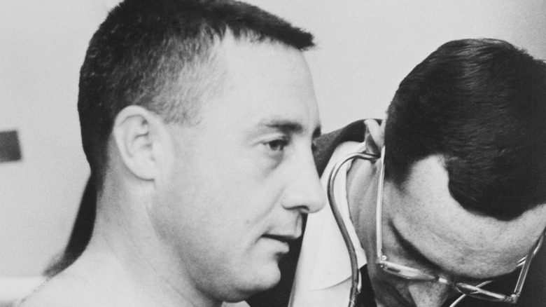 Astronaut Gus Grissom being checked out by a doctor
