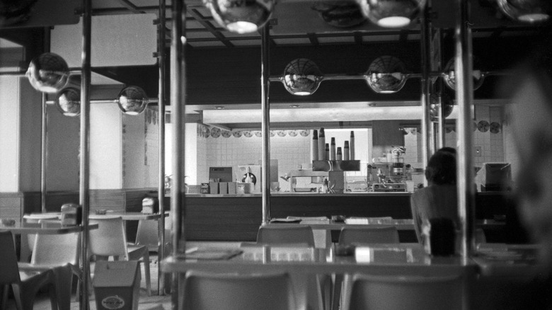 Lone woman sits in Burger Chef