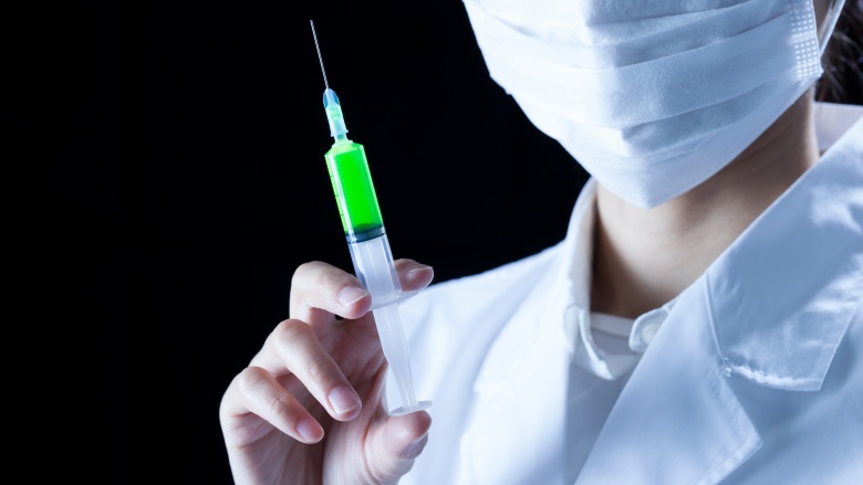 Doctor holding syringe 