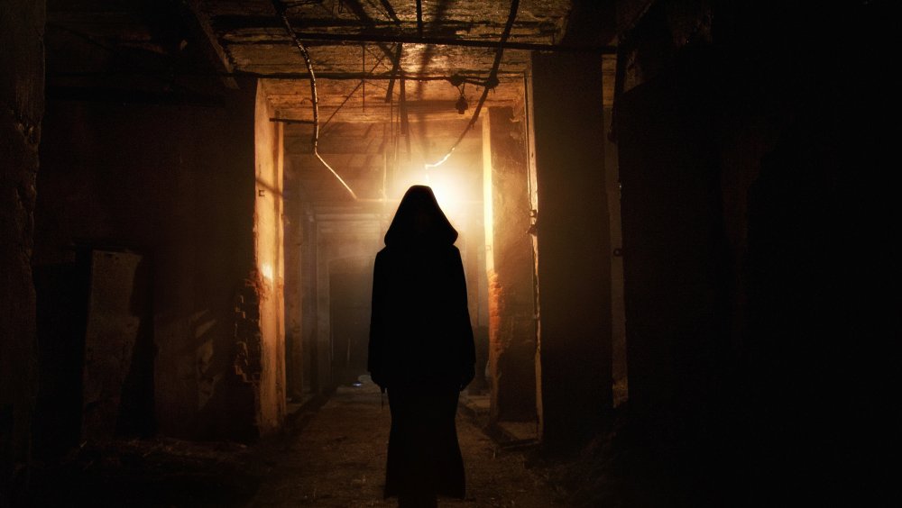 An image of a silhouette in a haunted house like setting