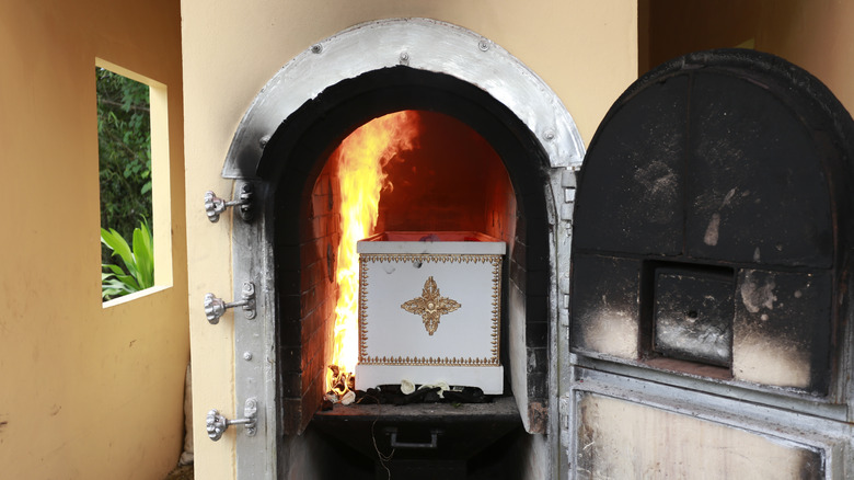 casket in crematorium with flames