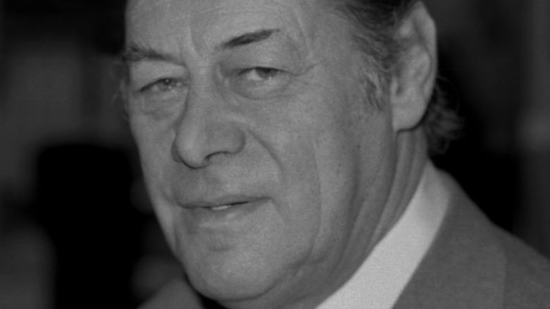 Rex Harrison half-smiling