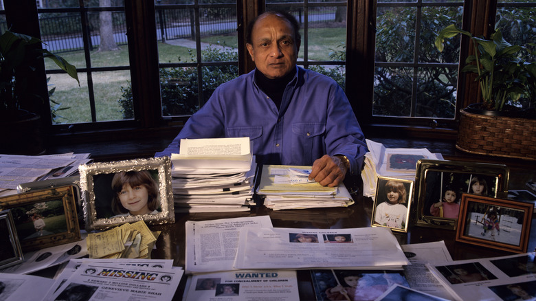 Businessman Bipin Shah with pictures and missing signs for his two daughters