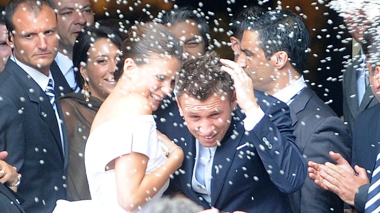 Wedding couple covered in rice