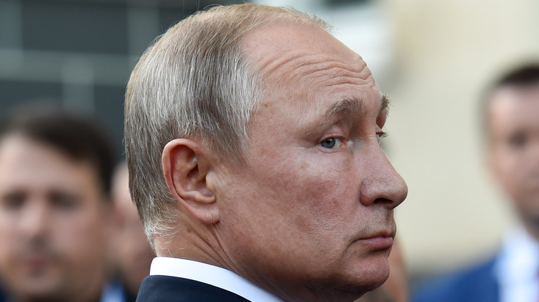 Vladimir Putin looking over his shoulder