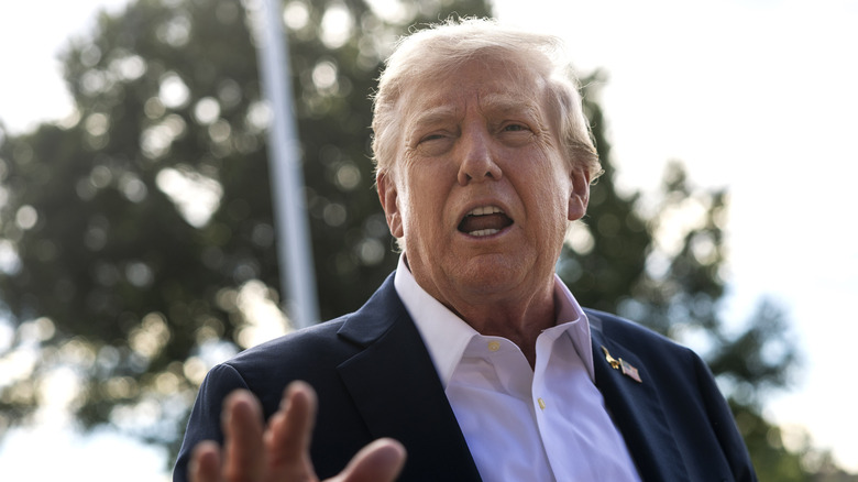Donald Trump speaking to the media with shirt collar open