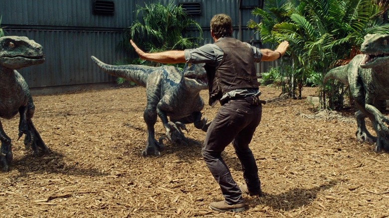 Velociraptors surrounding Chris Pratt's Owen Grady in Jurassic World