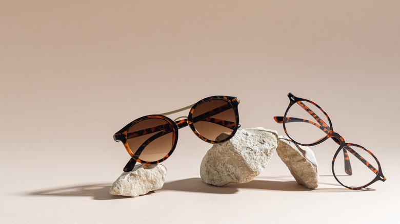 Two pairs of sunglasses on stones