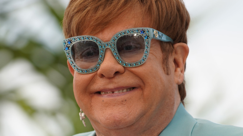 Elton John wearing sequined glasses