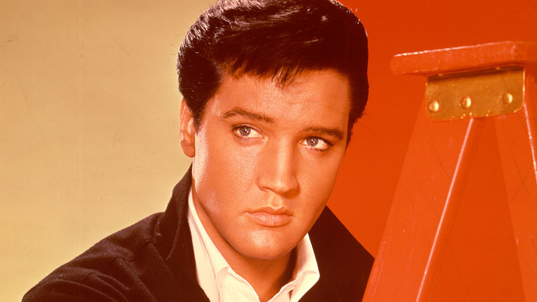 Elvis Presley by a ladder