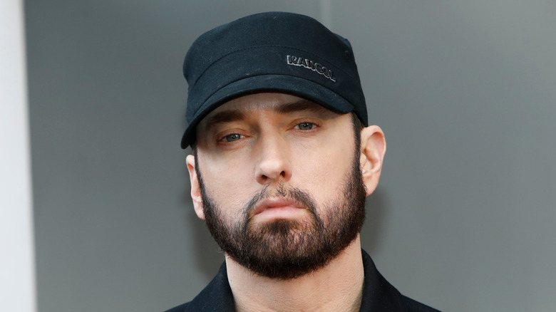 eminem black cap beard looking into camera