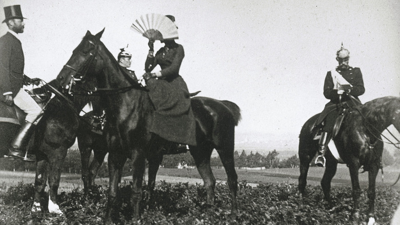 empress elisabeth of austria concealing her face beind a fan
