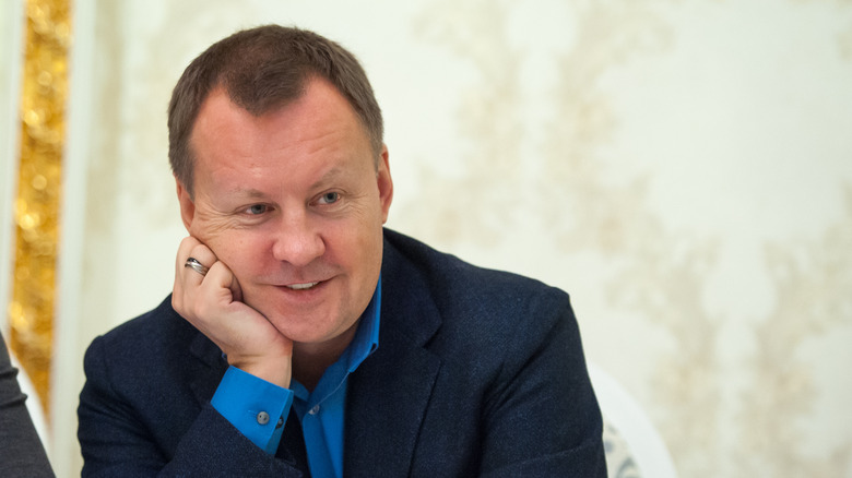 Denis Voronenkov  suit smiling head on hand