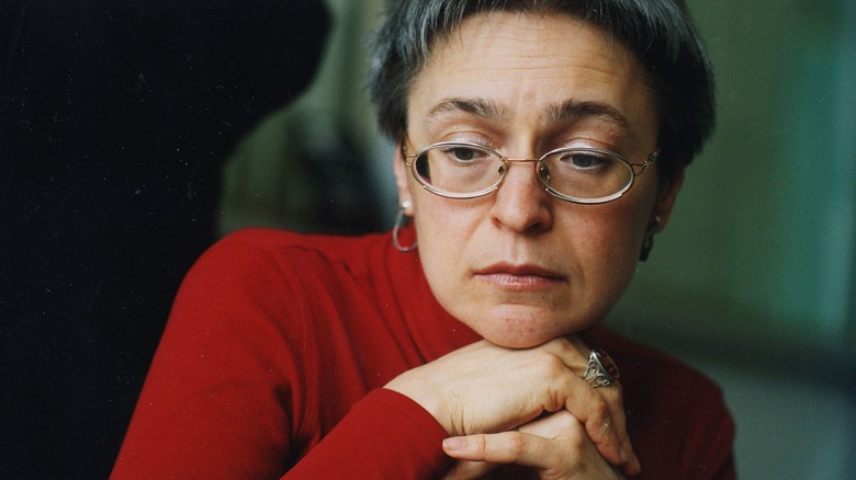 Anna Politkovskaya glasses head on hands