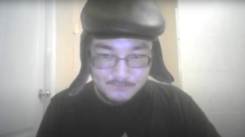 Yevgeny Khamaganov glasses black hat and shirt