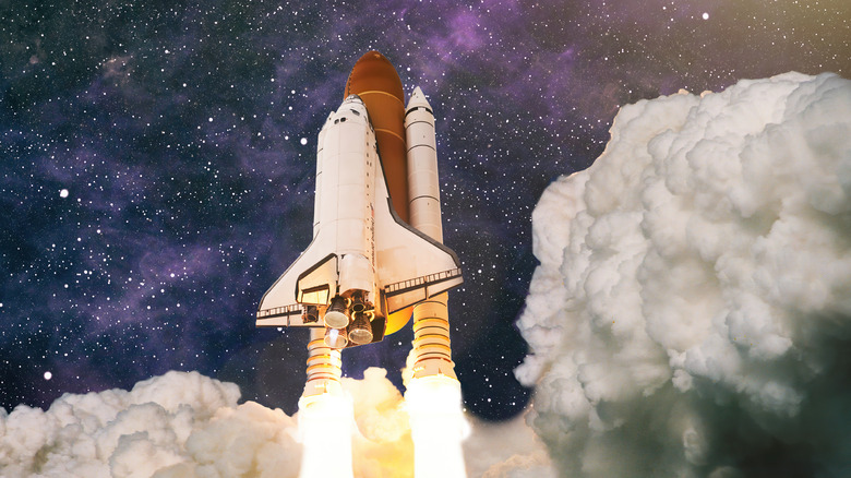 NASA space shuttle launching into sky