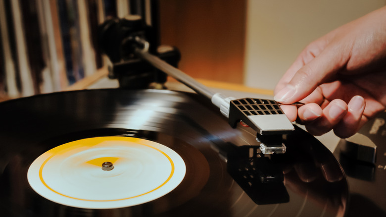 Woman's hand placing needle on record