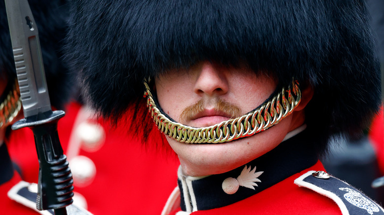 rguards looks out from underneath his bearskin hat