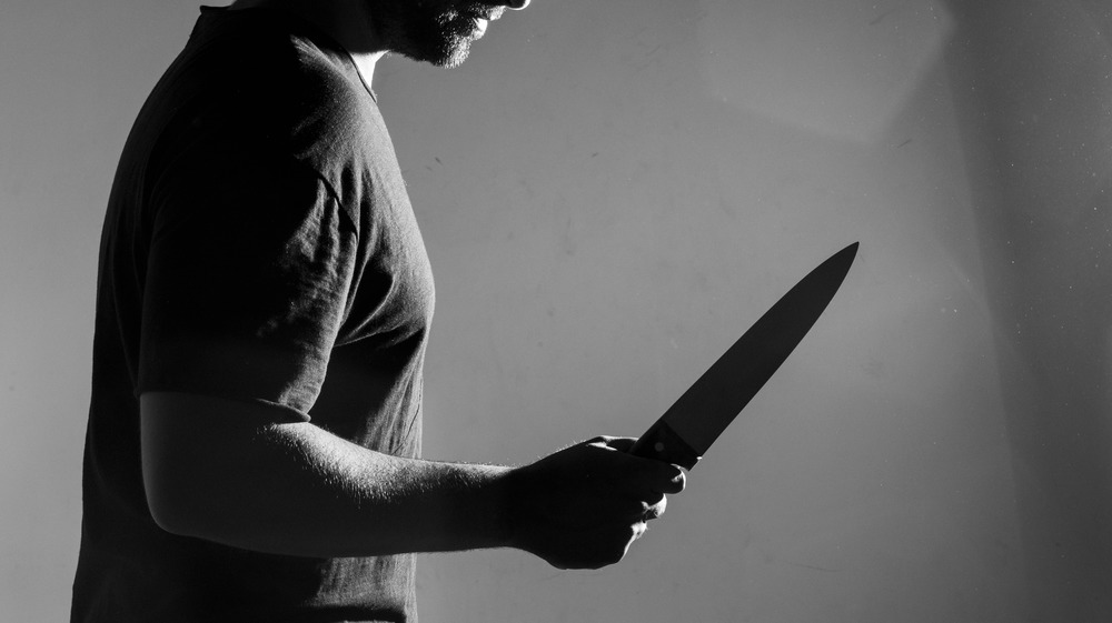 Man threateningly holding a kitchen knife